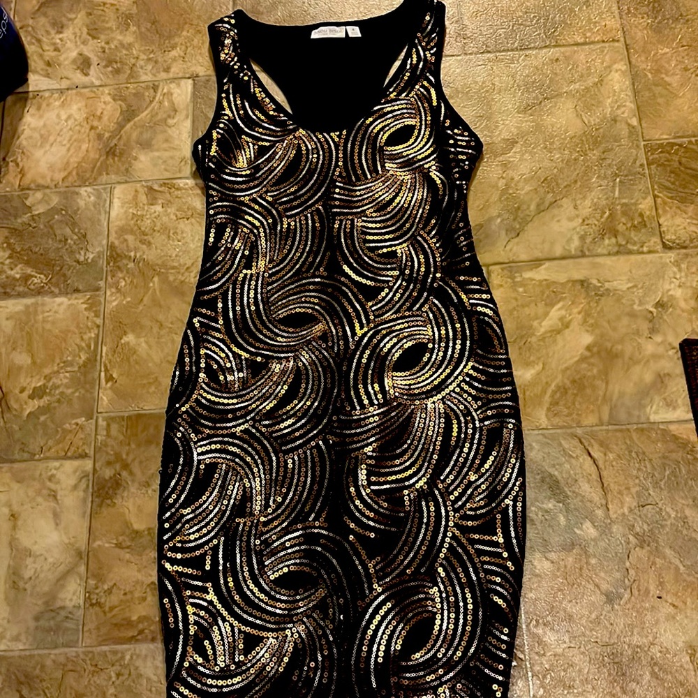 A mini black dress with gold sparkles. Size small and made by Bisou Bisou